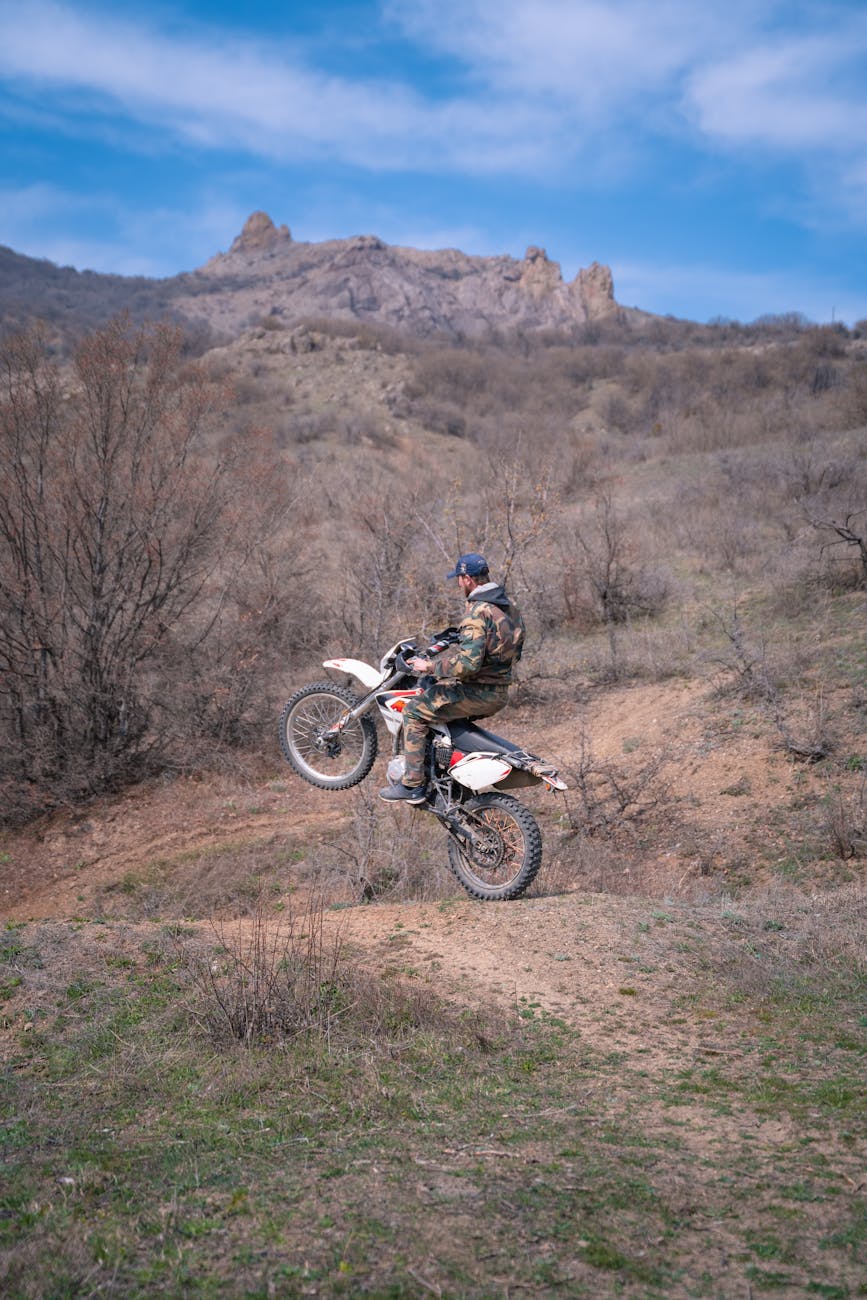 man riding on a motorbike on one wheel