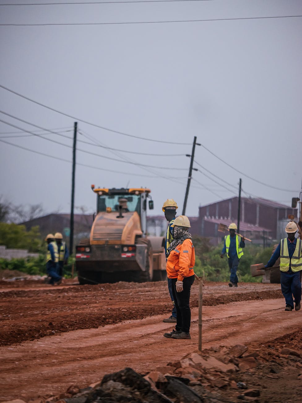 construction workers on a roadwork site with heavy machinery