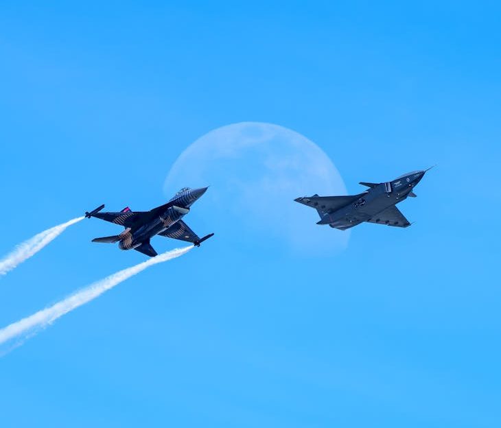 two military fighters aircraft against clear blue sky